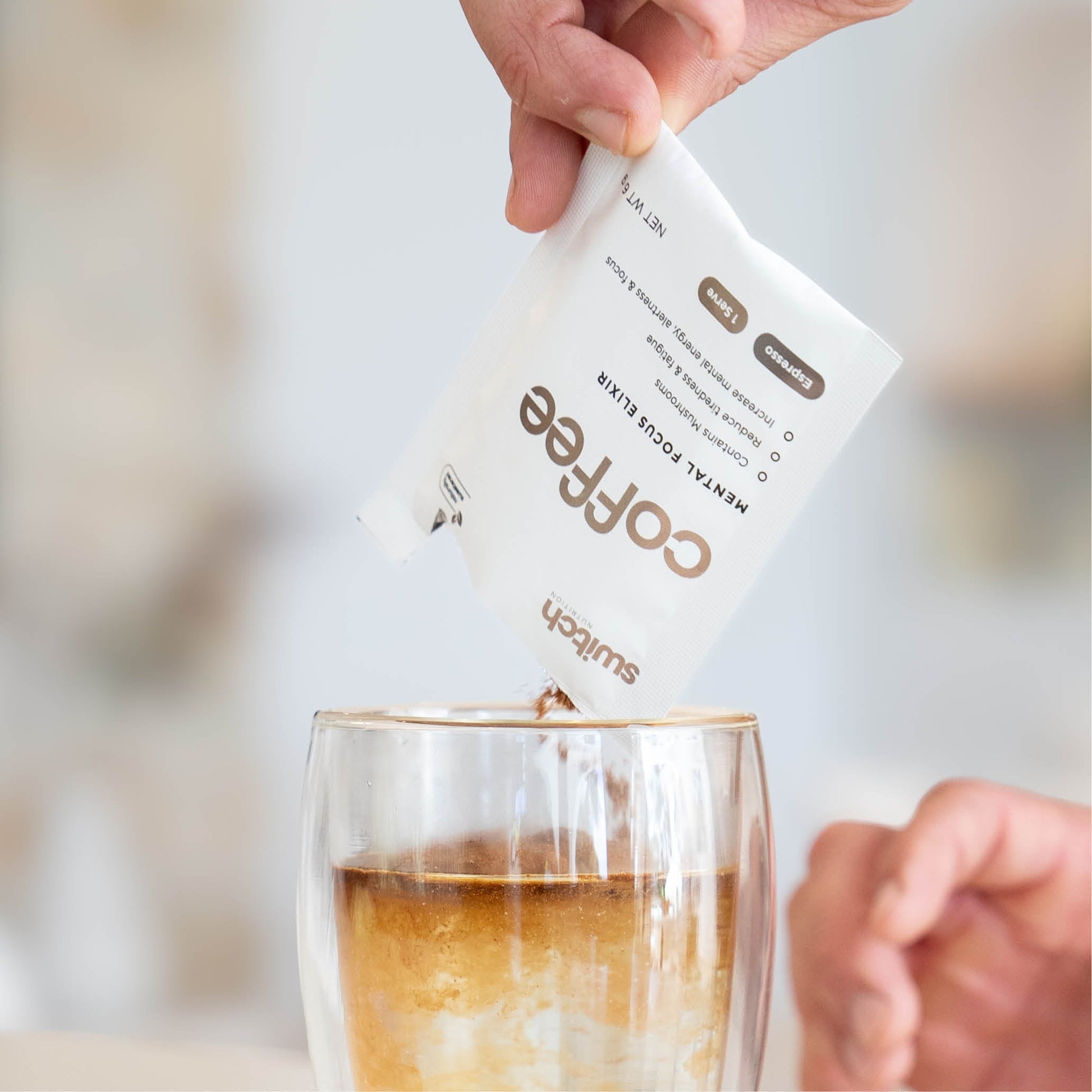 Coffee Switch Nootropic Mushroom Coffee open sachet being poured into a cup of hot water.