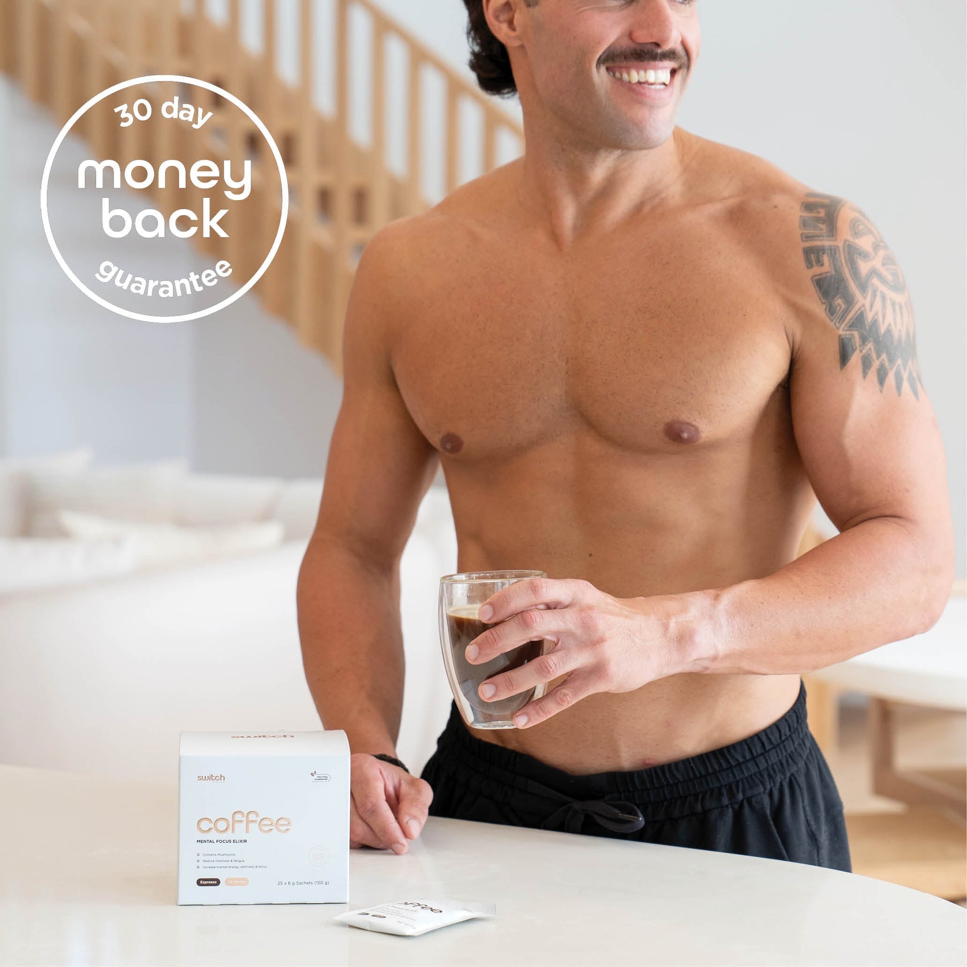 Man in kitchen standing in front of a box f Coffee Switch Nootropic Mushroom Coffee. There is a 30 day money-back guarantee in top left corner of image.
