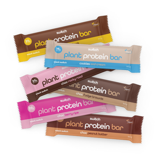 Switch Nutrition Plant Protein Bars in various flavours - Includes bars in Choc Peanut Butter, Cookies and Cream, Choc Rocky Road, Choc Fudge Brownie, Choc Berry Ripe, and Choc Honeycomb. Each bar is 60g, vegan, and offers a different protein content (ranging from 19g to 20g) per flavour. Each bar is wrapped in colour-coded packaging corresponding to its flavour.