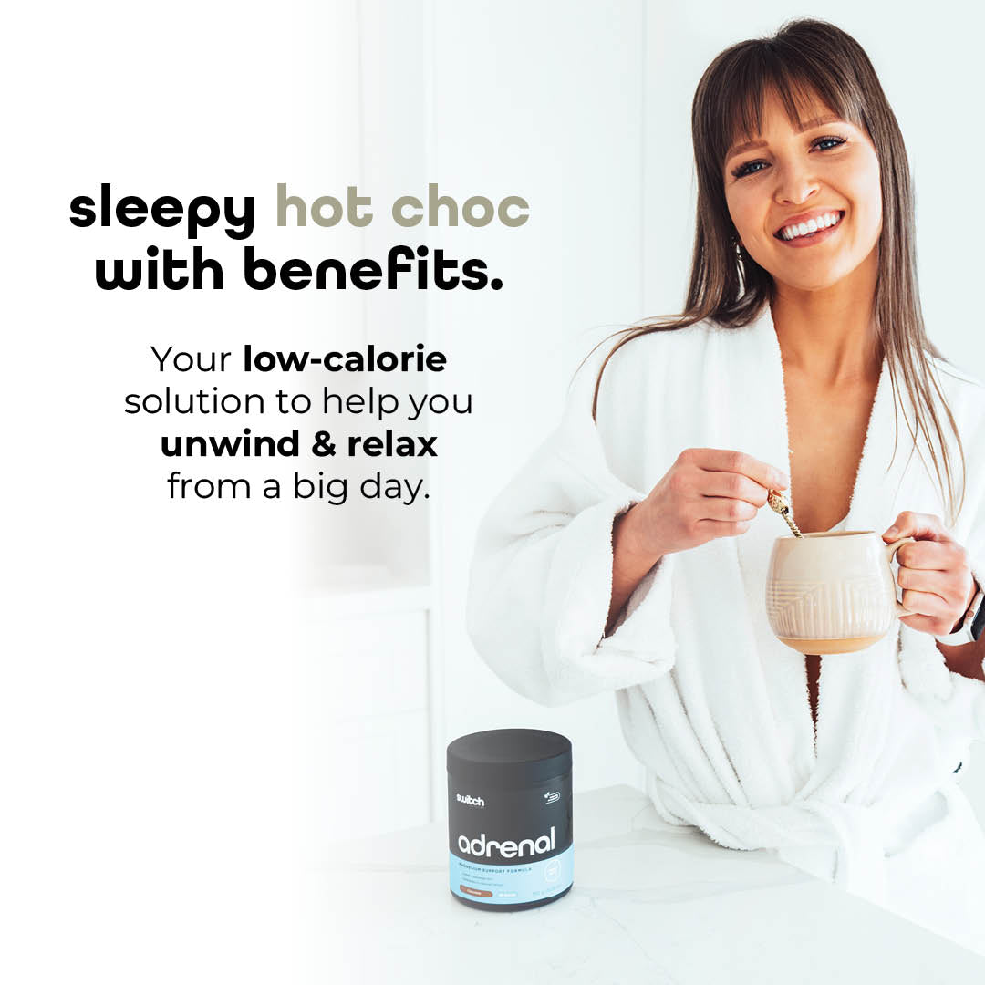 A woman in a white robe smiling, holding a mug of hot chocolate with a spoon, next to text 'sleepy hot choc with benefits' and additional text describing it as a low-calorie solution for unwinding and relaxing, with a blue jar labeled 'adrenal' on a white background.